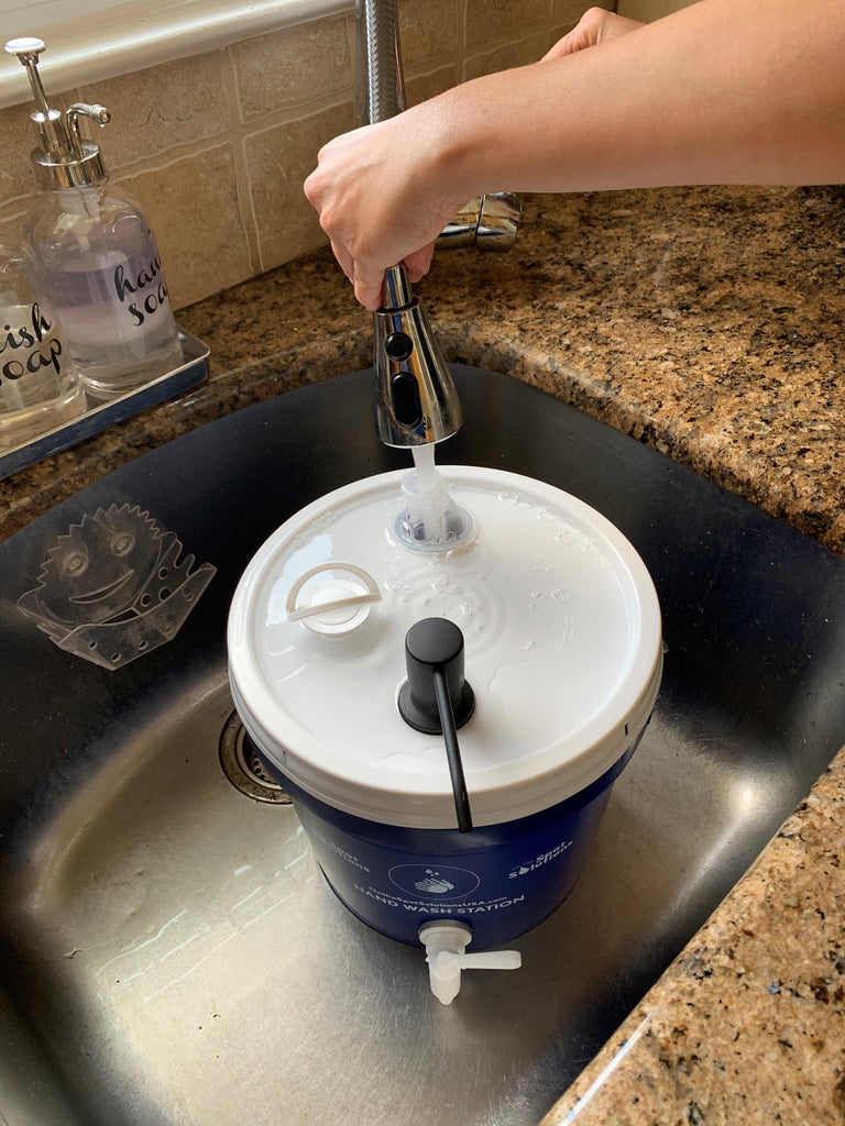 Hand-washing station [includes bucket with tap, bowl, and soapy water